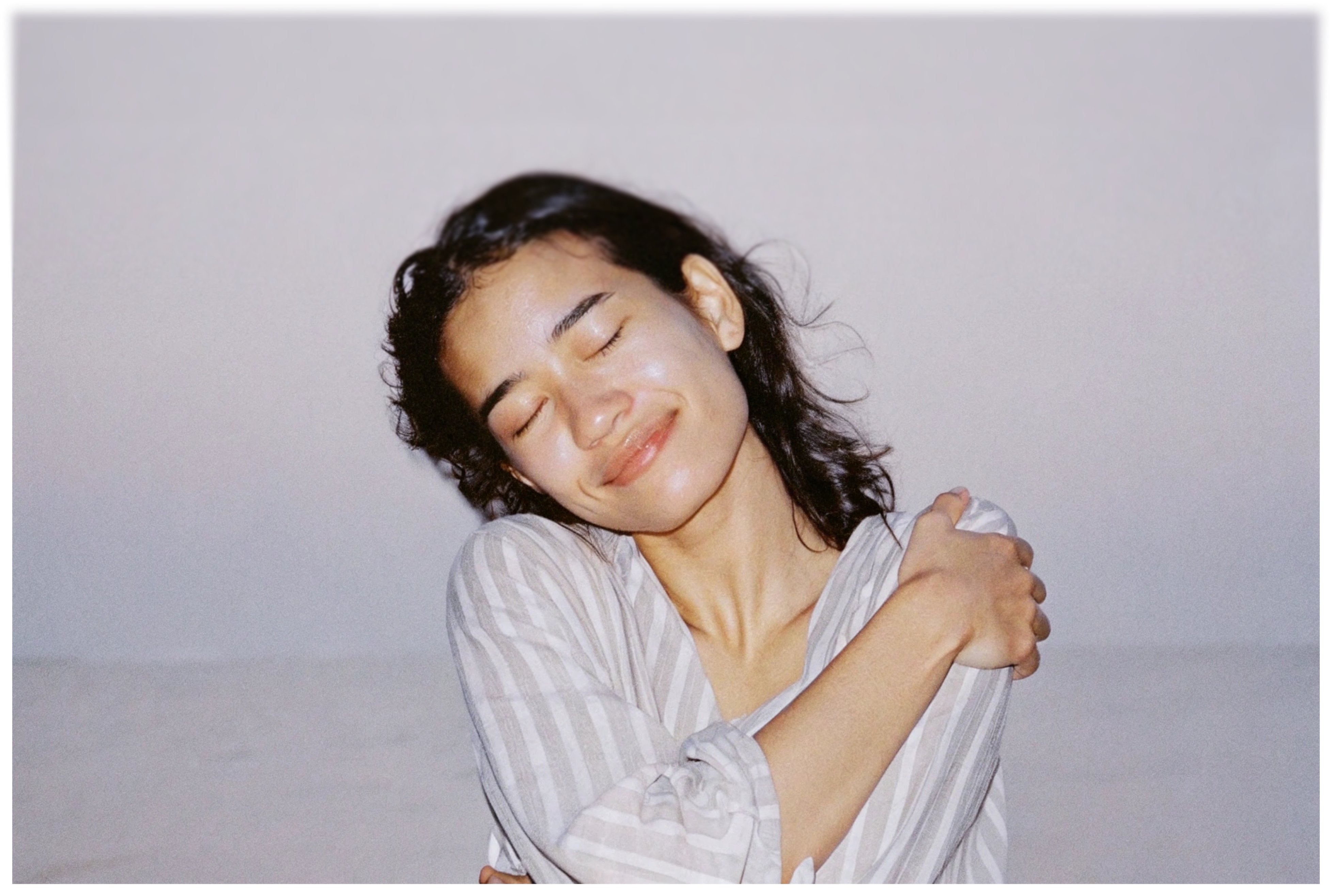 Happy woman embracing herself